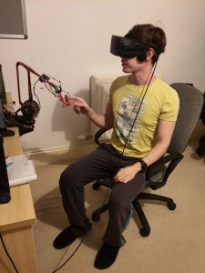 Alex using the VR headset and device he was sent.