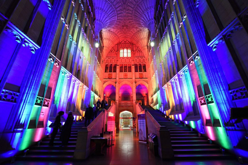 A photo of the interior of Wills Memorial Building lit up in Pride colours.