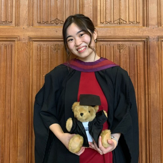 A picture of Emelyn Tan smiling in her graduation gown