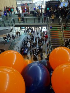 A busy bristol beacon at leats years careers fair. up front, purple and orange balloons 