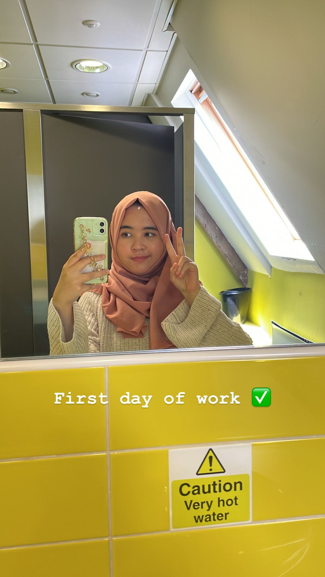 Jasmine taking a selfie, smiling. Reads 'First day of work.'
