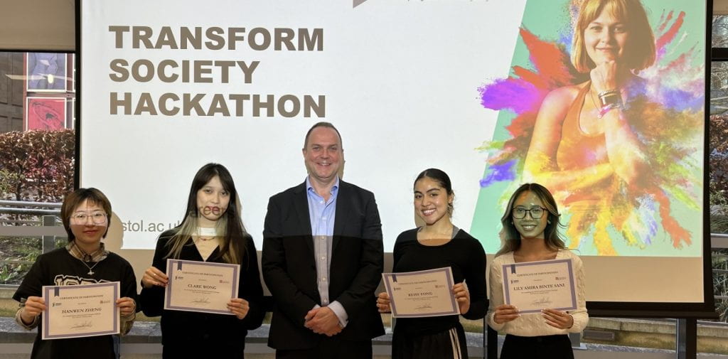 The winners of the hackathon collect their certificates with James Darley, CEO of Transform Society. 