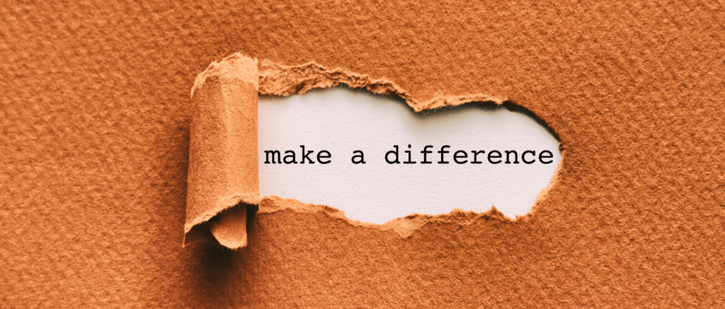An orange, textured piece of card with a hole ripped out to reveal the phrase make a difference. 